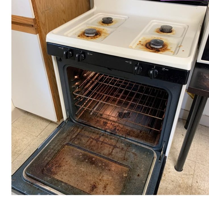 The same range and oven before, with burnt-on grease