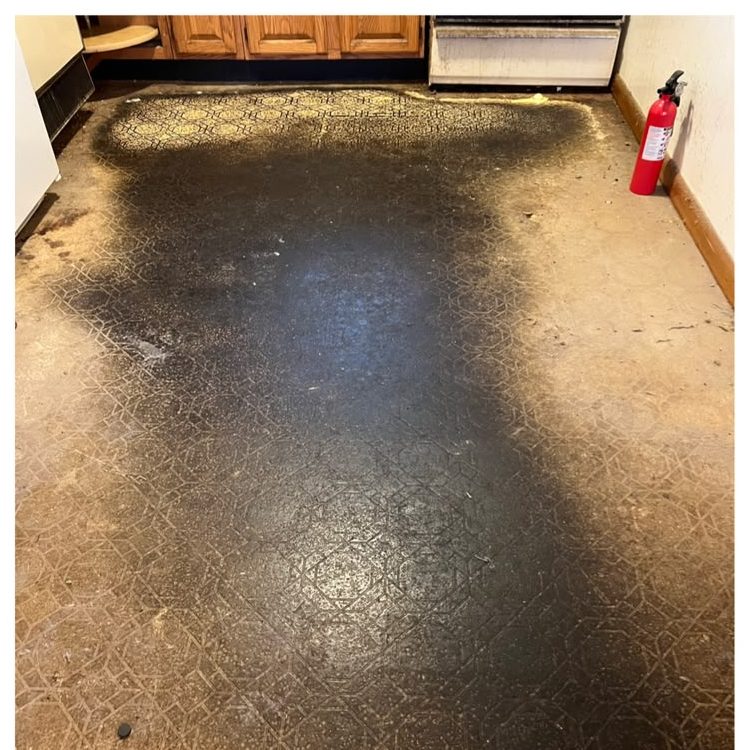 The same floor before cleaning, dark with built-up grime